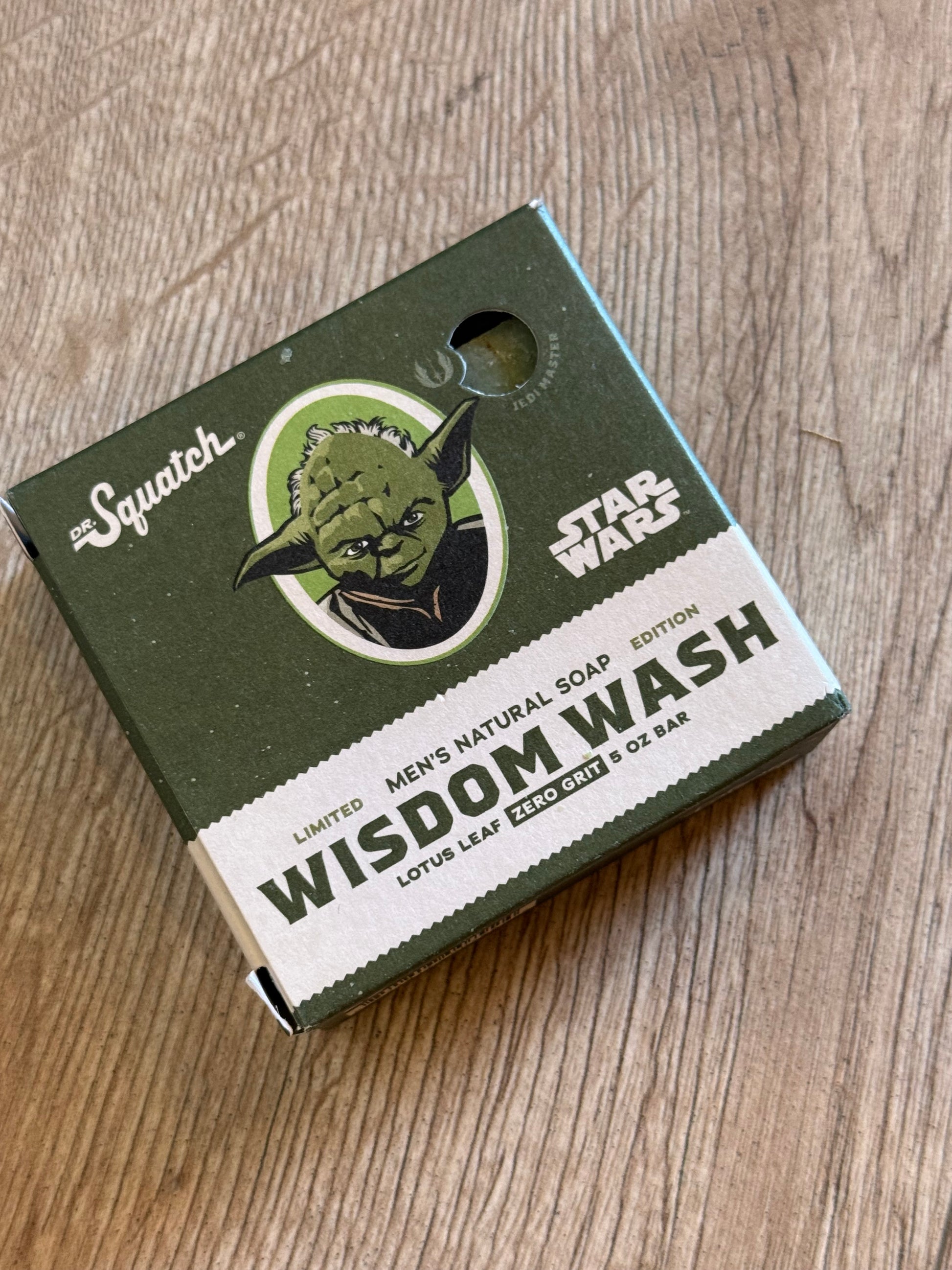 Green and white box with a logo on a wooden surface