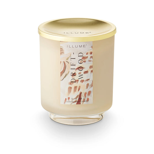 Illumine Driftwood candle with gold lid on a white background