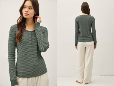 Woman wearing a green long-sleeve shirt and white pants, shown from front and back against a white background.