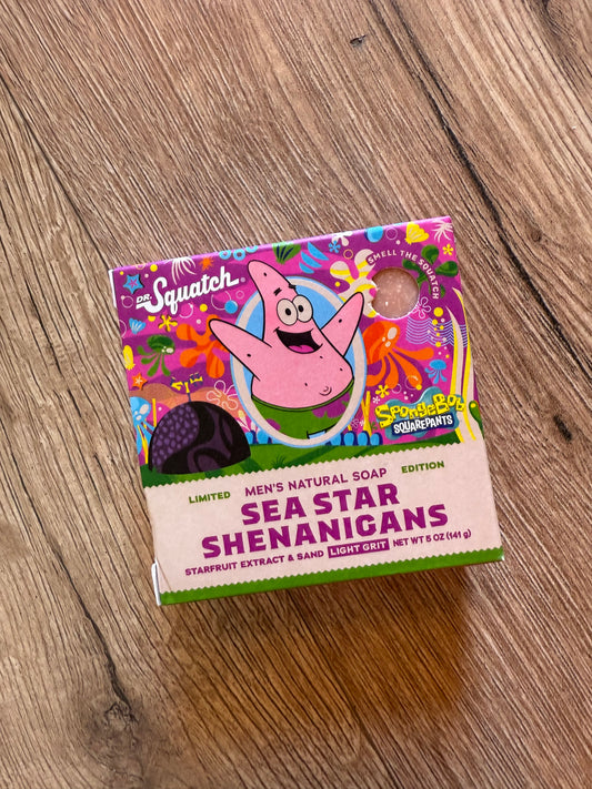 Colorful box of Men's Natural Soap with a cartoon character on a wooden surface