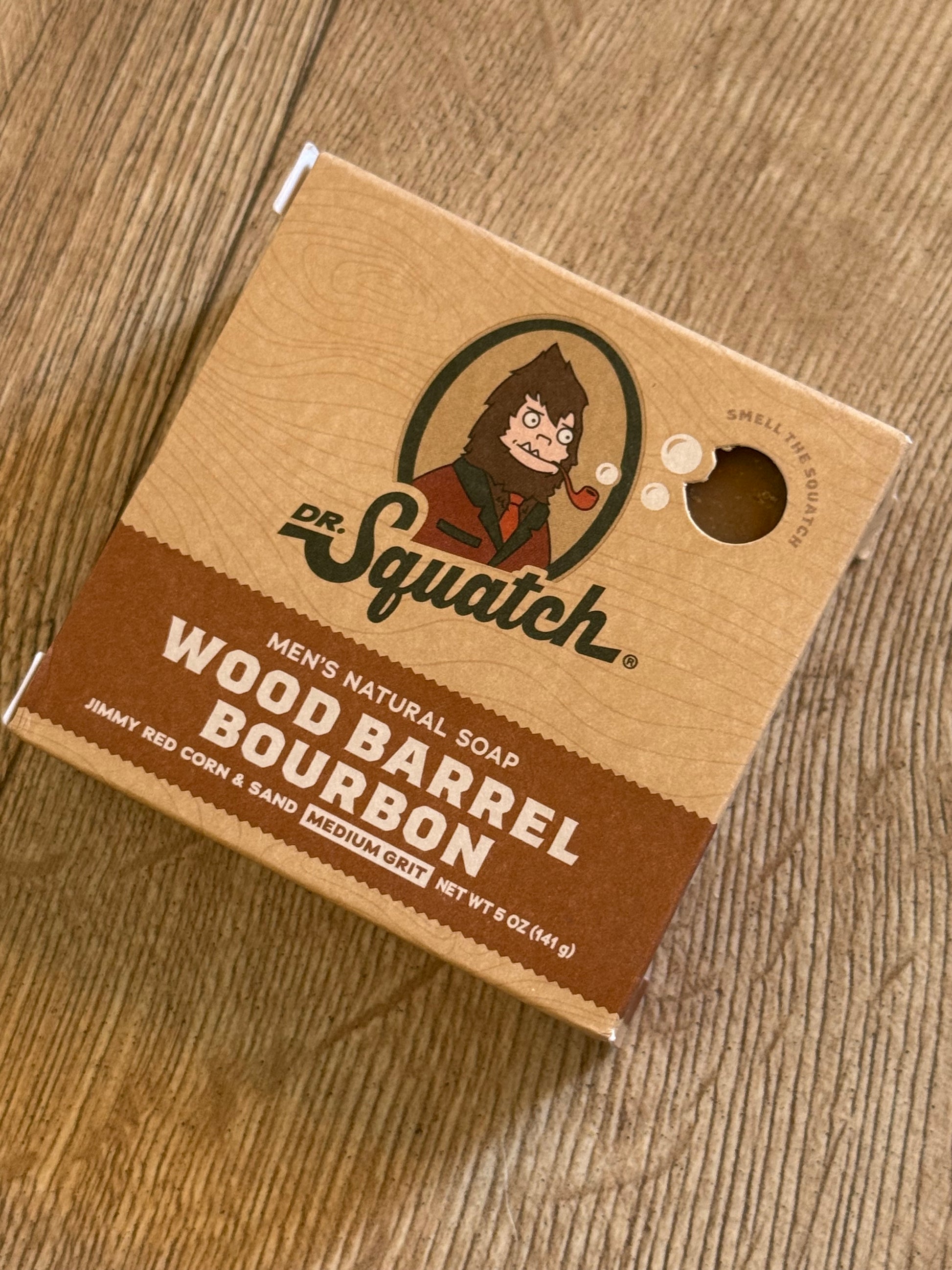 Dr Squatch Wood Barrel Bourbon soap packaging on a wooden surface