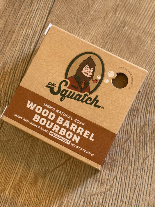 Dr Squatch Wood Barrel Bourbon soap packaging on a wooden surface