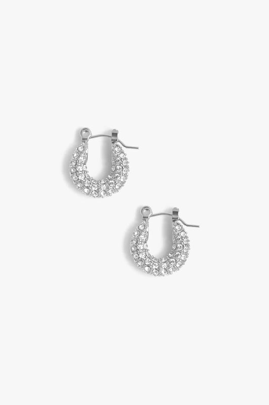 Pair of silver hoop earrings with clear gemstones on a white background