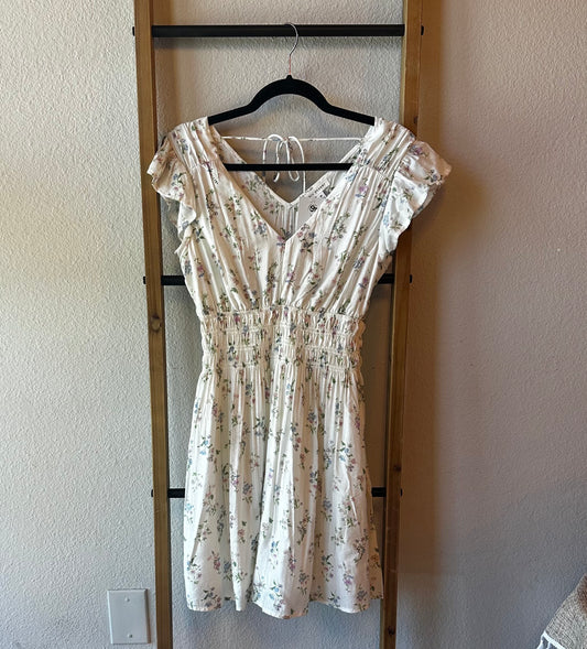  ivory dress features delicate pink floral detailing and a cinched waistband for a flattering silhouette. 
