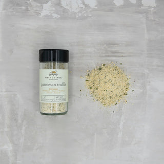 Bottle of parmesan truffle seasoning on a textured gray surface