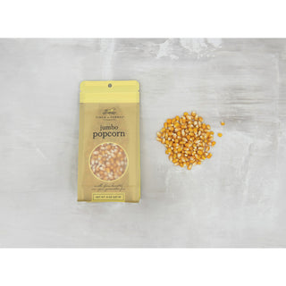 Fisher & Ferman jumbo popcorn package with unpopped kernels on a light gray background