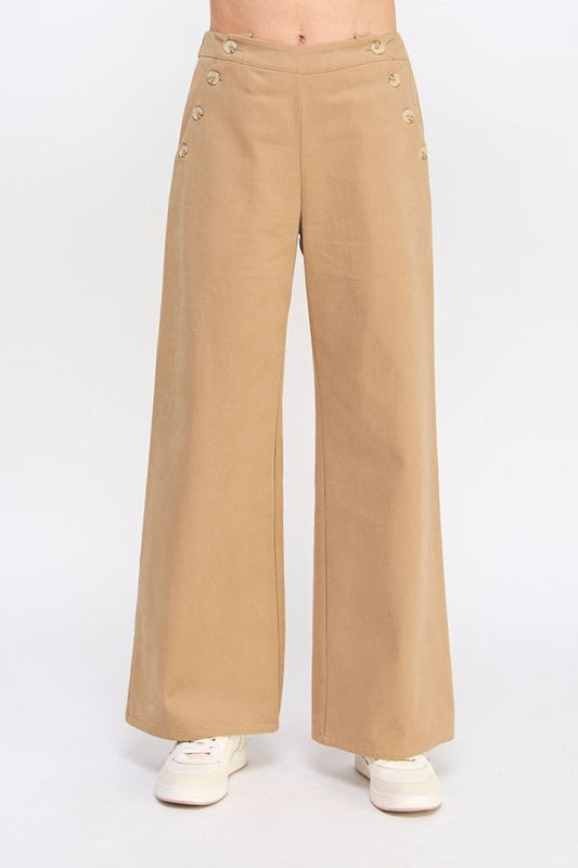 Tan wide-leg pants with button details on a white background